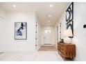 Bright hallway features white walls, light wood floors and stylish décor at 1110 Elm St, Denver, CO 80220