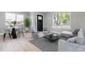 Inviting living room featuring contemporary furnishings, large windows, and a neutral color palette at 3657 Krameria St, Denver, CO 80207