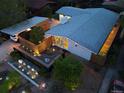 Aerial view of home and xeriscaped yard at dusk with carport and lighting at 2545 S Lowell Blvd, Denver, CO 80219