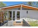 Home's front entrance featuring stylish wood and glass door with accent lighting at 2545 S Lowell Blvd, Denver, CO 80219
