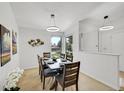 Elegant dining room with modern lighting, a wooden table, and seating for six at 11267 W Colorado Pl, Denver, CO 80232