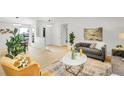 Bright living room featuring neutral walls, comfortable seating, and a cozy dining area at 11267 W Colorado Pl, Denver, CO 80232