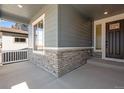 Charming porch features stone accents, and a stylish front door with glass insert panels at 3422 N Gold Bug Ct, Aurora, CO 80019