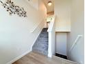 View of staircase with neutral walls, carpeted steps, and wood flooring at 94 Vale St, Palmer Lake, CO 80133