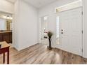 Bright entryway with stylish flooring, a white front door, and views into other rooms at 11621 Colony Loop, Parker, CO 80138