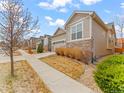 A lovely home featuring manicured lawns, stone accents, and attractive landscaping at 11621 Colony Loop, Parker, CO 80138