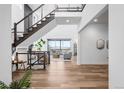 Grand entryway boasts high ceilings, modern staircase, and beautiful hardwood floors at 16262 W 95Th Ln, Arvada, CO 80007