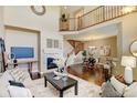 Cozy living room with fireplace, hardwood floors and open layout at 4742 Raven Run, Broomfield, CO 80023