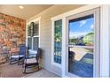 Inviting front porch features seating, brick accents, and decor for a cozy outdoor space at 9994 Quintero St, Commerce City, CO 80022