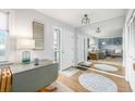 Welcoming entryway featuring hardwood floors and ample lighting and large mirrors at 11455 W 17Th Pl, Lakewood, CO 80215