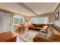 Spacious living room with large windows, comfortable seating, and a dining area at 4642 Plettner Ln, Evergreen, CO 80439