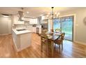 Bright, eat-in kitchen with stainless appliances, quartz counters, a custom hood vent and access to the yard at 10253 W 68Th Way, Arvada, CO 80004