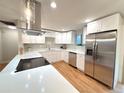 Bright, modern kitchen with stainless appliances, quartz counters, new cabinets, and hardwood floors at 10253 W 68Th Way, Arvada, CO 80004