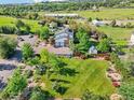 Aerial view of property showcasing large lawn, mature trees, and two-car garage at 767 Ellis St, Golden, CO 80401