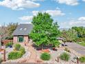 Charming brick home with mature tree, brick walkway, and lovely landscaping at 767 Ellis St, Golden, CO 80401