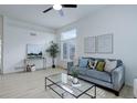 Comfortable living room with neutral decor, a ceiling fan, and a view of the outdoors at 16159 W 70Th Pl, Arvada, CO 80007
