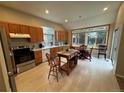Bright, eat-in kitchen with stainless steel appliances and a center island at 9806 Hooker Ct, Westminster, CO 80031