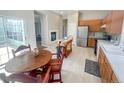 Bright kitchen with stainless steel appliances, a fireplace, and access to outdoor space at 9806 Hooker Ct, Westminster, CO 80031