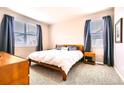 Cozy bedroom with natural light, carpet and a comfortable bed at 14758 Normande Dr, Mead, CO 80542