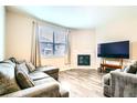 Cozy living room featuring a fireplace and large windows for natural light, with comfortable seating at 14758 Normande Dr, Mead, CO 80542