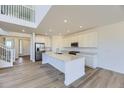 Modern kitchen with white cabinets, stainless steel appliances, and large island with sink at 2968 S Poppy St, Morrison, CO 80465