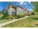 Beautiful condominium complex exterior showing well-manicured landscaping and inviting walkways at 2239 Calais Dr # 11F, Longmont, CO 80504