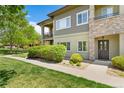 Charming condo with stone accents, lush landscaping, and a welcoming entrance at 2239 Calais Dr # 11F, Longmont, CO 80504