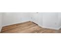 An empty room showing flooring and a baseboard with a white door and white walls at 6616 N Nepal St, Aurora, CO 80019