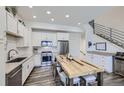 Modern kitchen with stainless steel appliances and rustic wooden table at 2214 Central Park Way, Superior, CO 80027