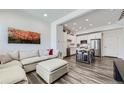 Open-concept living room flows into modern kitchen with island seating at 2214 Central Park Way, Superior, CO 80027