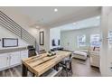 Bright living space with wooden dining table and stairs with railing at 2214 Central Park Way, Superior, CO 80027