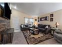 Comfortable living room featuring plush seating, a large rug, and ample natural light at 10752 Steele St, Northglenn, CO 80233