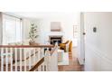 Bright living room featuring a fireplace, hardwood floors, and neutral decor at 1140 Devonshire Ct, Lafayette, CO 80026
