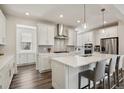 Modern kitchen featuring white cabinets, stainless steel appliances, and a large center island at 11151 W 53Rd Dr, Wheat Ridge, CO 80033