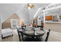 Cozy living room with a dining table, white sofas and a well lit room with a vintage ceiling fan at 1136 N Logan St # 8, Denver, CO 80203