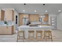 Contemporary kitchen with a quartz-topped island, wooden bar stools, and stainless steel appliances at 328 Quay St, Lakewood, CO 80226