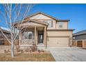 Charming two-story home with stone accents, neutral color palette, and an attached two-car garage on a beautiful sunny day at 1788 Taos St, Brighton, CO 80603