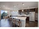 Beautiful kitchen featuring a large center island, stainless steel appliances, and modern pendant lighting at 2305 Prospect Ln, Broomfield, CO 80023