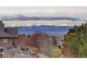 Scenic mountain views from the backyard deck of this home nestled among trees and open space at 2305 Prospect Ln, Broomfield, CO 80023