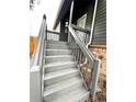 Exterior stairway leading up to the entrance of this cozy gray home at 4243 Flanders St, Denver, CO 80249