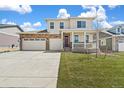 Beautiful two-story home featuring a spacious three-car garage, a covered front porch, and well-kept front yard at 1850 Sawtooth Mountain Dr, Berthoud, CO 80513