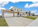 Attractive two-story home with a brick-accented garage and cozy covered porch, set in a suburban neighborhood at 1850 Sawtooth Mountain Dr, Berthoud, CO 80513