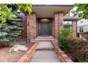 Stately brick home featuring an elegant entryway with double doors and refined details at 8047 S Fairfax Ct, Centennial, CO 80122