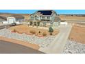Suburban two-story home with solar panels, detached garage, and xeriscaped front yard; perfect for energy efficiency at 16360 Paris Way, Brighton, CO 80602