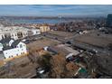 An aerial view of the property and the neighborhood showcasing its proximity to community amenities and nearby lake at 1571 Sheridan Blvd, Lakewood, CO 80214