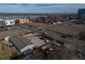An aerial view of the property highlights its location with access to the street and nearby lake at 1571 Sheridan Blvd, Lakewood, CO 80214