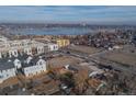 Stunning aerial view of the neighborhood with the buildings, street, and lake creating a picturesque scene at 1571 Sheridan Blvd, Lakewood, CO 80214