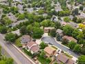 Aerial view of a residential neighborhood, showcasing tree-lined streets, mature trees, and community pool at 5860 W Atlantic Dr, Lakewood, CO 80227