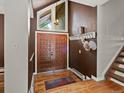 Welcoming foyer with hardwood floors, a decorative double-door entrance, and coat hooks near the staircase at 5860 W Atlantic Dr, Lakewood, CO 80227