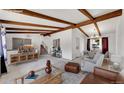Staged living room with exposed beams and an open floor plan concept at 3792 S Fenton Way, Denver, CO 80235